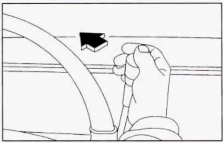 Line drawing of a hand holding a cable with a black arrow pointing to it, against a plain background (no text or symbols)