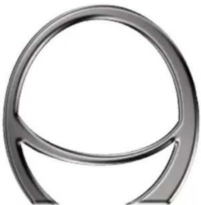Close-up of a metallic circular object with a curved handle, resembling a stylized letter or symbol (no text or symbols present)
