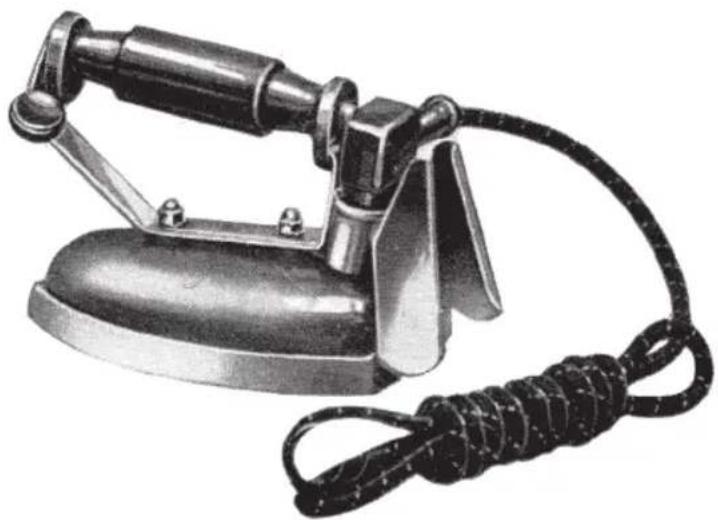 Vintage iron (£) with coiled cord and metal handle (no text or symbols visible)