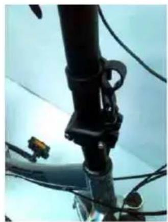 Close-up of a black mechanical device with attached clamps and cables, no visible text or symbols