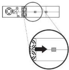 Diagram showing a device with labeled components and an arrow pointing to a rectangular block, possibly indicating a process or signal flow.