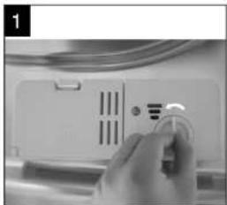 Close-up of a hand holding a small circular button next to a white electronic device panel (no visible text or symbols)