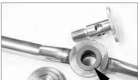 Close-up of mechanical components including a threaded fitting and flange, with no visible text or symbols.