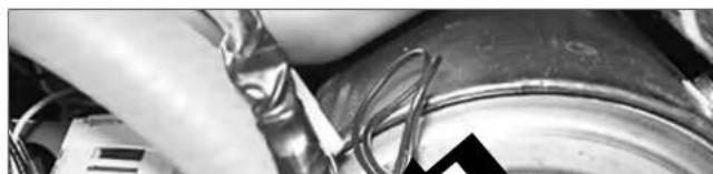 Close-up of hands holding a metallic tool next to a cylindrical container with coiled wires (no visible text or symbols)