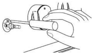 Hand holding a cylindrical tool with a knob, no visible text or symbols