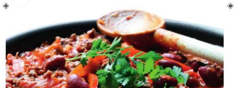 Close-up of a stewed dish with red beans, carrots, and cilantro garnish in a black bowl (no text or symbols visible)