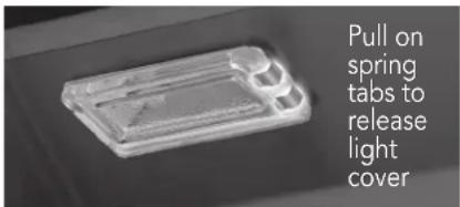 Pull on spring tabs to release light cover