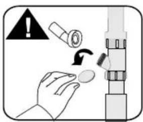 Diagram showing a hand holding a small object with a warning symbol and a magnified view of the object being inserted into a cylindrical component.