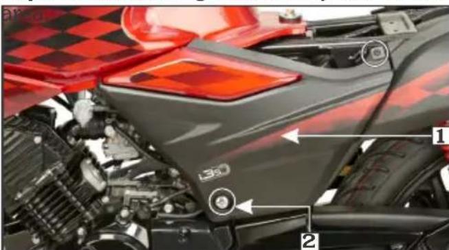 Lear view of a motorcycle engine with labeled parts and components, including red checkered background and numbered parts.