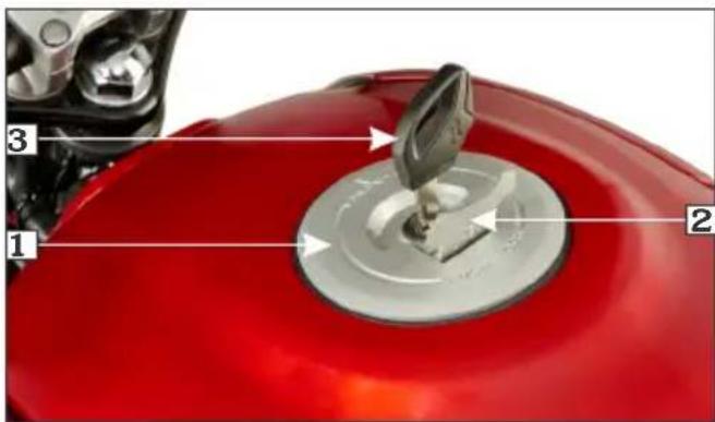 Close-up of a red car tire with labeled parts 1, 2, and 3, showing mechanical components and a metallic component.