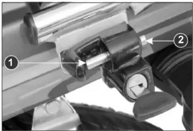 Technical diagram showing mechanical components with numbered labels 1 and 2 pointing to specific parts of a device.
