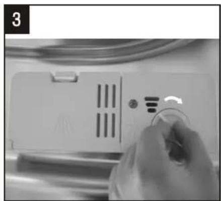 Close-up of a hand adjusting a white electronic device with control buttons and a paper clip (no visible text or symbols)