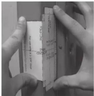 Close-up of hands holding a printed label with technical specifications and markings