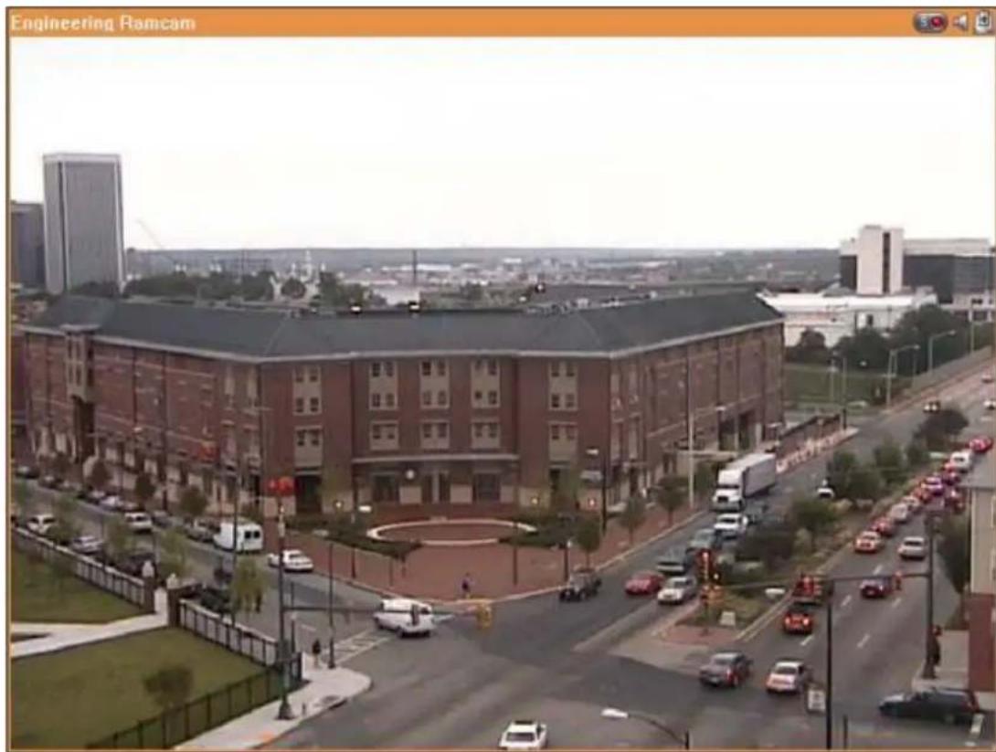 Exterior view of a large industrial building with surrounding roads and parked cars, labeled 'Engineering Ramcam' in the top-left corner.