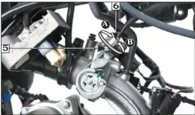 Labeled mechanical assembly diagram showing components A, B, and numbered parts 5, 6 with visible wiring and valve indicators