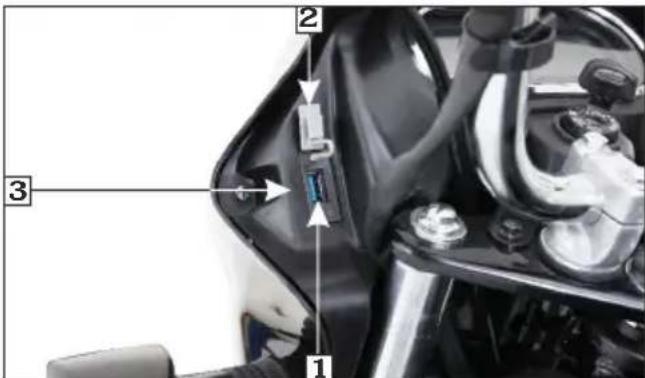 Labeled diagram of a motorcycle's front panel showing parts numbered 1, 2, and 3 with arrows indicating assembly or connection.
