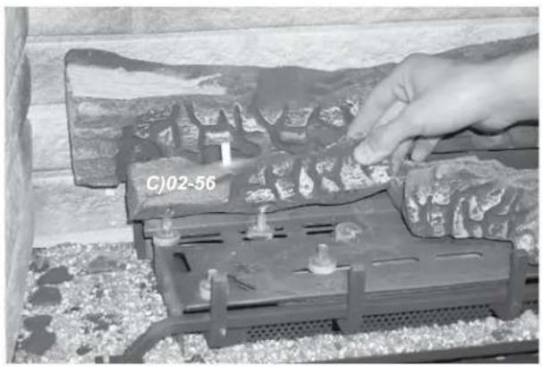 Close-up of a hand adjusting a mechanical component with visible bolts and a label 'CJ02-56' (no readable text or symbols beyond label)