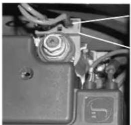 Close-up of a mechanical component with wires and a small logo (no visible text or symbols)