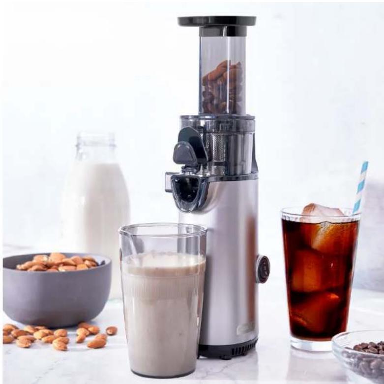 Modern coffee maker with glass of milk and red liquid, accompanied by scattered nuts and a straw (no text or symbols visible)