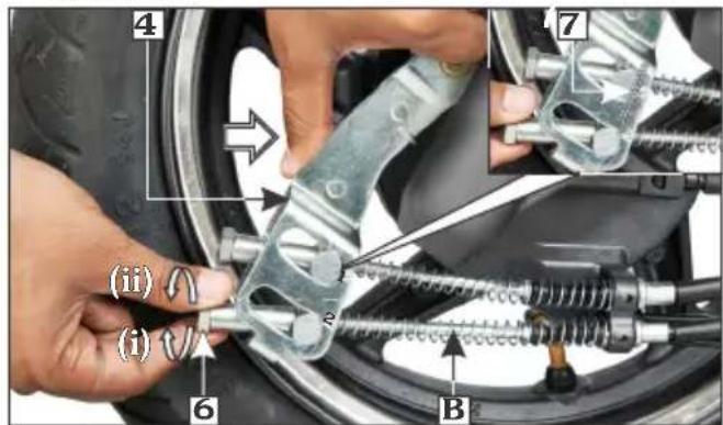 Mechanical repair diagram showing a hand adjusting a car tire with labeled parts and directional arrows