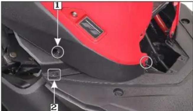 Close-up of a red motorcycle seat with numbered annotations highlighting key components