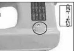 Close-up of a white industrial machine component with a circular dial indicator and a vertical label showing Chinese characters.