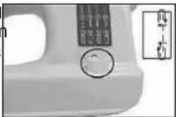 Close-up of a white electronic device with a circular button and a vertical label showing Chinese characters.