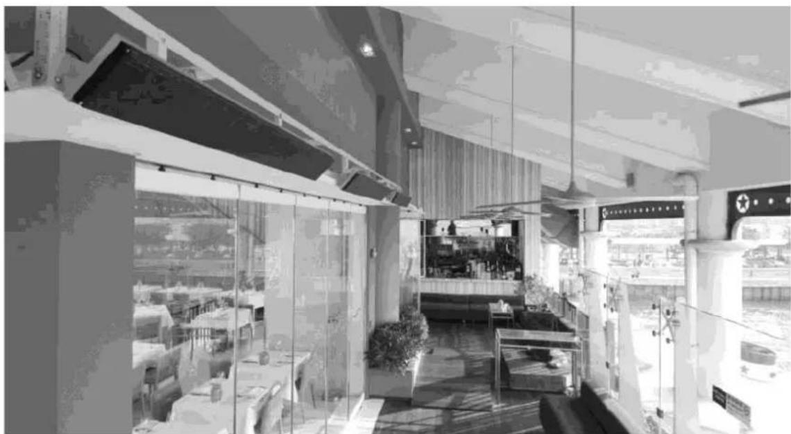 Interior view of a modern restaurant or café with glass doors, seating areas, and outdoor signage (no readable text)