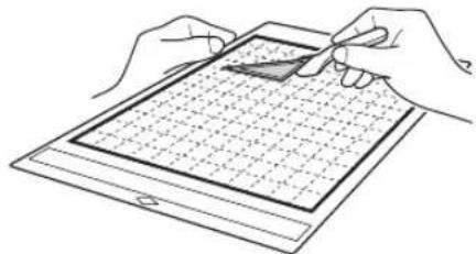 Line drawing of two hands holding a tablet with a grid pattern (no text or symbols)