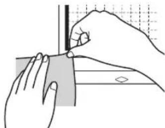 Illustration of hands using a tool to cut a rectangular object, with no visible text or symbols