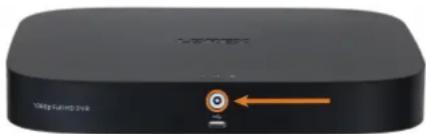 Black rectangular electronic device with a circular button and orange arrow pointing to it (no visible text or symbols)