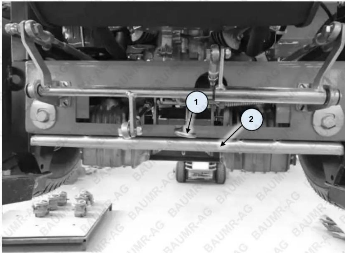 Technical diagram of a mechanical assembly with labeled parts 1 and 2, showing components like gears and shafts.