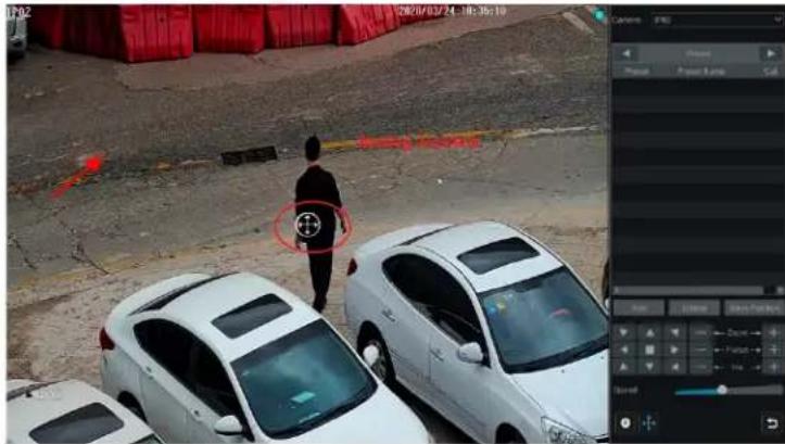 Security camera screenshot showing a person standing at a parking lot with visible red arrows and a circled symbol, alongside multiple cars in the foreground.