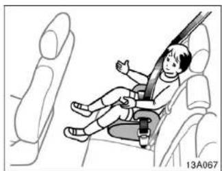 Illustration of a child seated in a car seatbelt inside a vehicle, with no visible text or symbols.