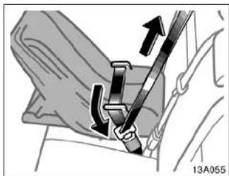 Mechanical diagram showing a belt buckle assembly with arrows indicating direction (no text or symbols)
