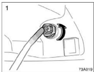 Diagram of a car interior showing a cable being inserted into a plug (no text or symbols present)