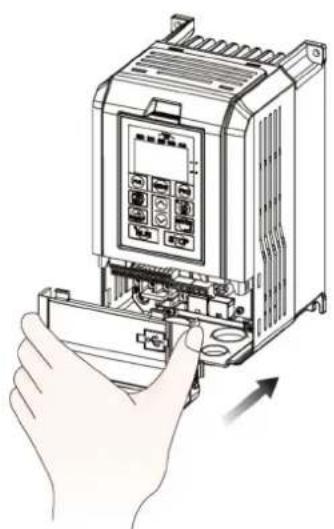 Illustration of a hand inserting a device into a rack, showing internal components and a directional arrow (no text or symbols)