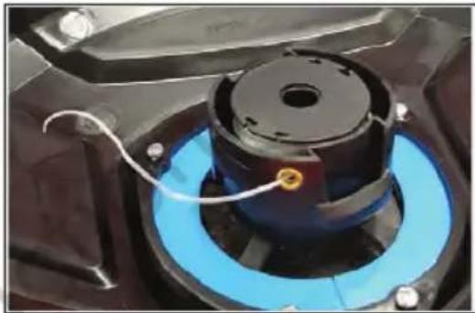 Close-up of a mechanical component with blue ring and black housing, no visible text or symbols