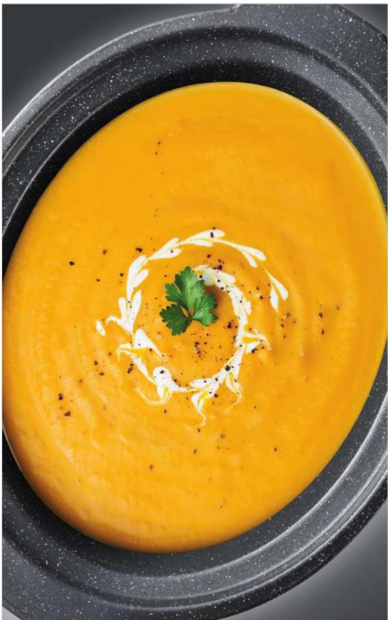Close-up of a bowl of orange creamy soup with garnish, no visible text or symbols