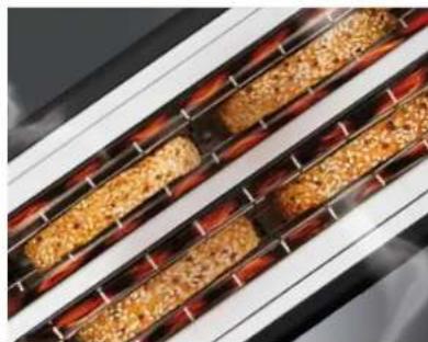 Close-up of a grater with visible chocolate chips and molten sugar (no text or symbols)