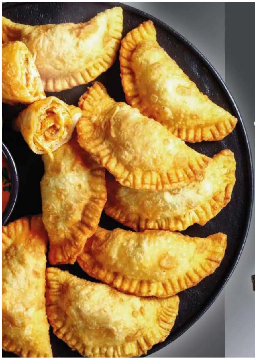 Close-up of golden-brown fried pastries on a black plate, no text or symbols visible.