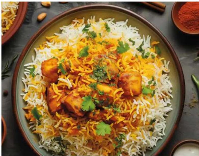 A bowl of Indian-style marinated rice dish with visible chilies and garnishes, served in a ceramic bowl (no text or symbols).