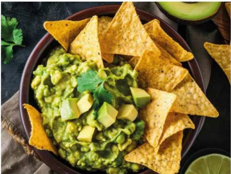 Bowl of avocado salad with diced potatoes and garnish, accompanied by fresh yellow triangular cards (no text or symbols visible).