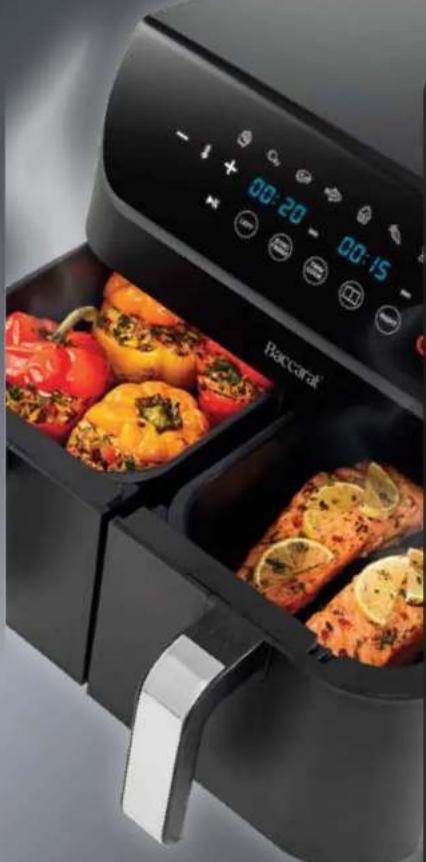 Air fryer with red and yellow bell peppers in a black tray, displaying digital clock and menu icons (no text or symbols on main subject)