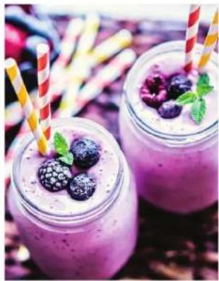 Two glass jars filled with purple smoothie, blueberries, and striped straws (no text or symbols visible)