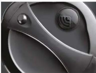Close-up of a glossy, curved metallic object with circular features and a small logo (no visible text or symbols)