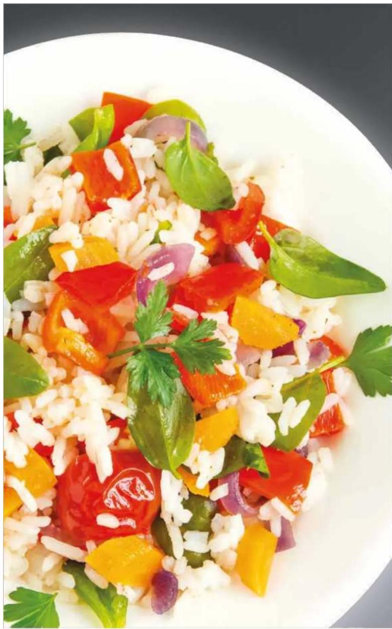 Close-up of a colorful salad with rice, carrots, tomatoes, and herbs on a white plate (no text or symbols visible)