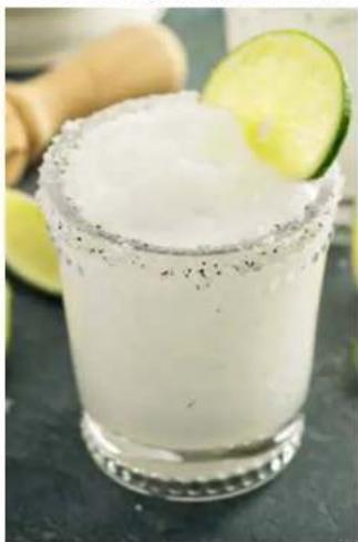 Close-up of a margarita in a clear glass with lime slices, no visible text or symbols