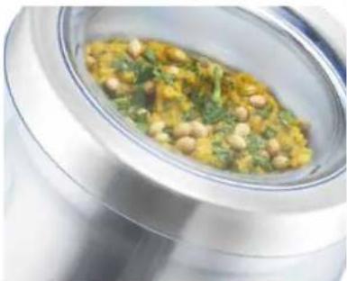 Close-up of a food dish with visible herbs and sauce, served in a metal bowl (no text or symbols)