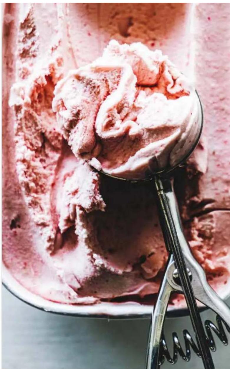 Close-up of ice cream scoops with a metal scoop, no visible text or symbols